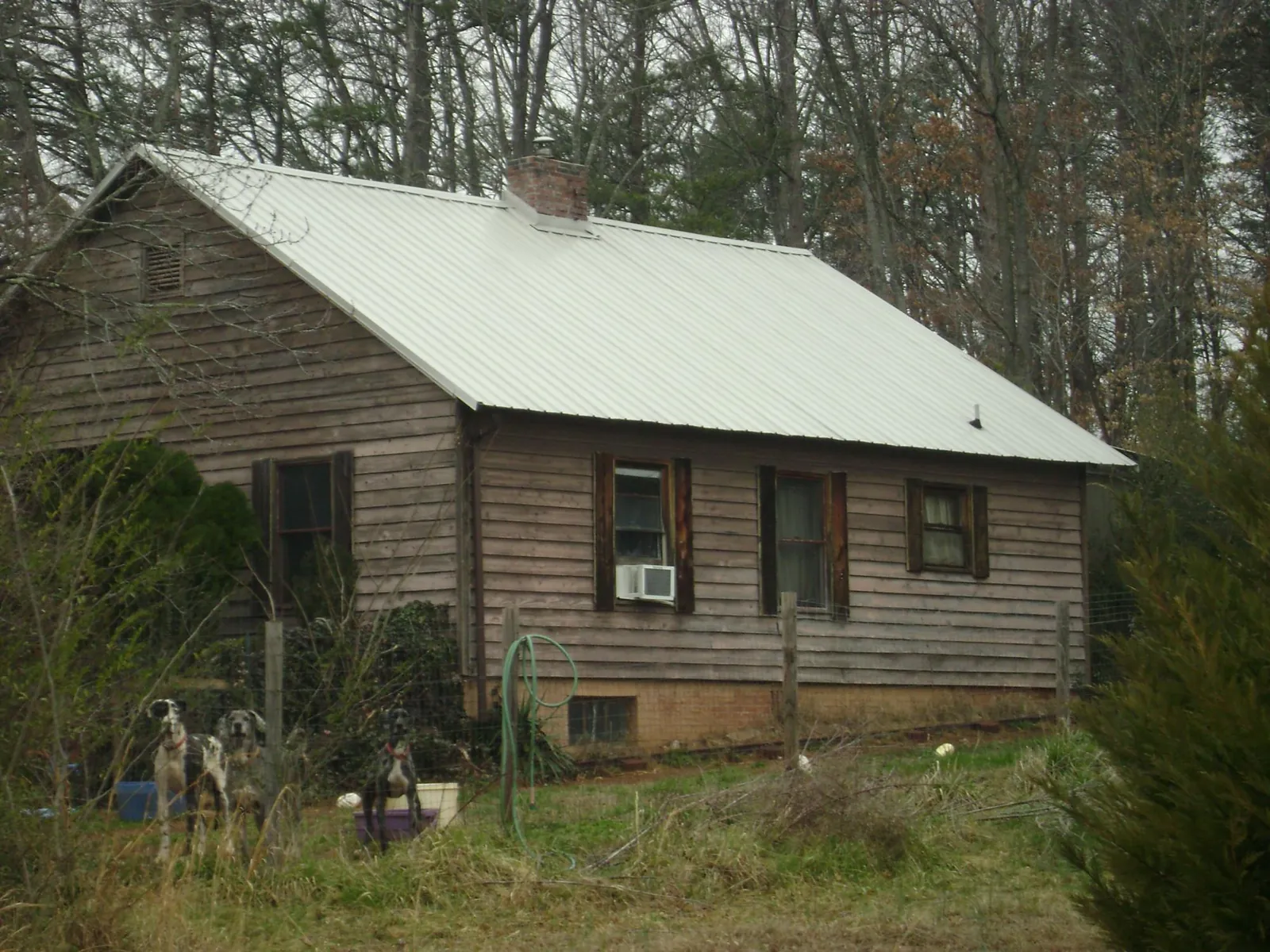 White metal roof on an old wood sided farmhouse, from a Metal Roof Installation job in Lucernemines